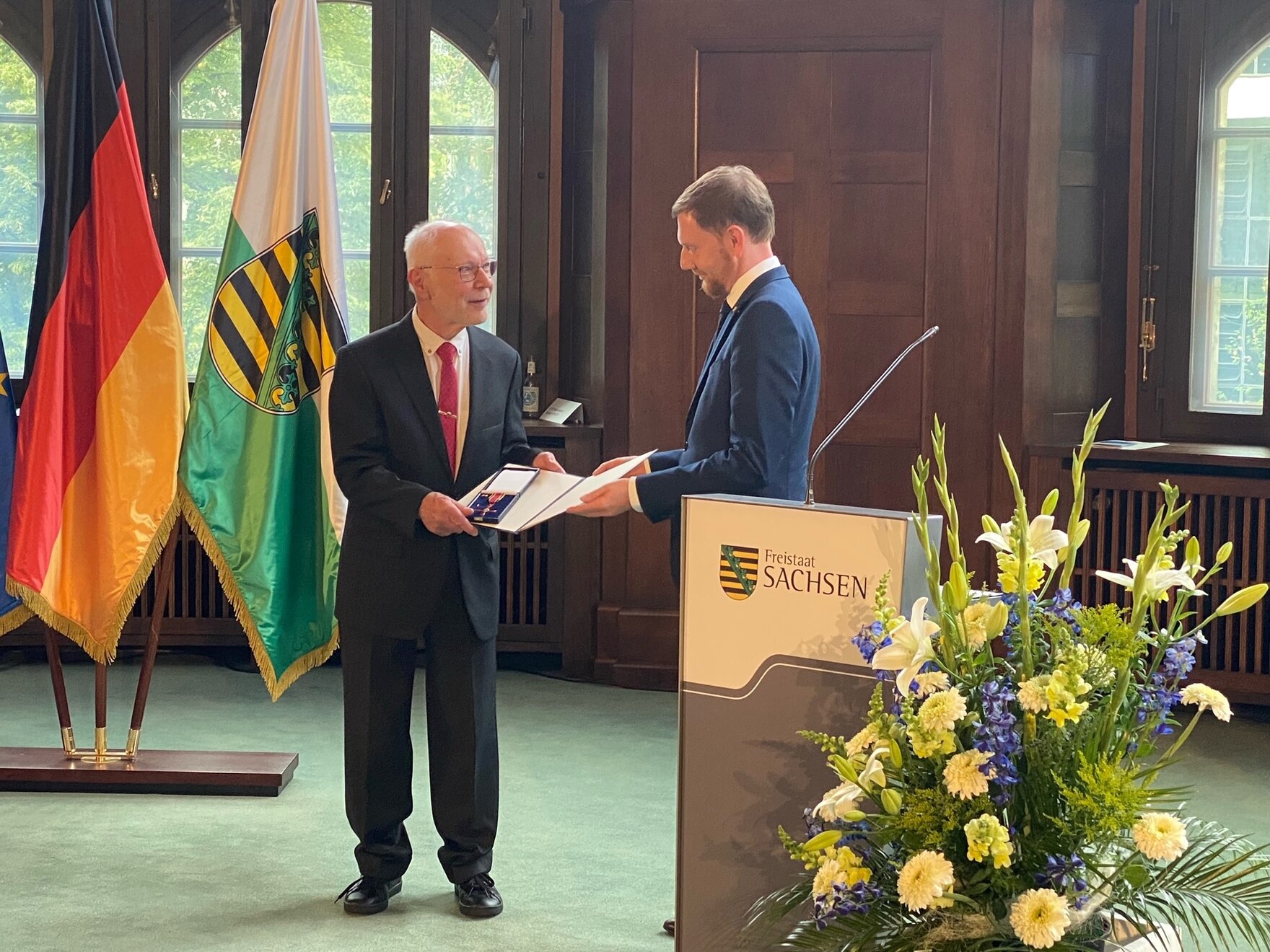 Herr Zempe bekommt von Ministerpräsident Michael Kretschmer das Bundesverdienstkreuz überreicht